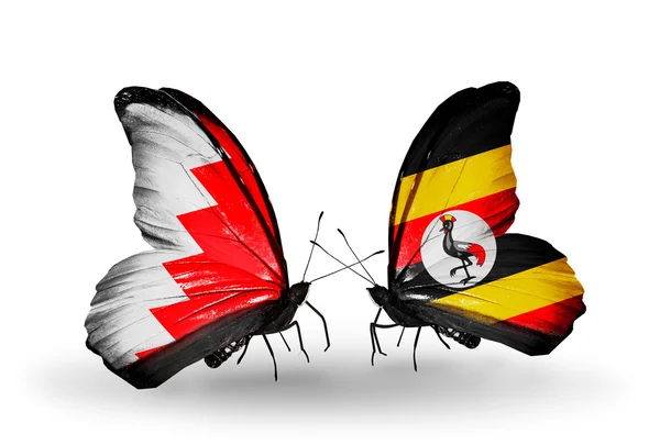 Vlinders met Bahrein en Oeganda vlaggen op vleugels — Stockfoto