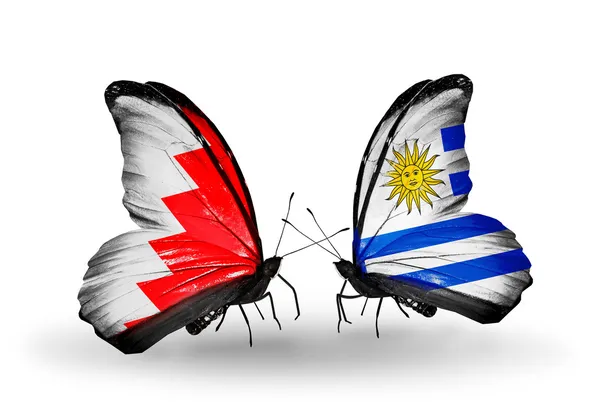 Butterflies with Bahrain and Uruguay flags on wings — Stock Photo, Image