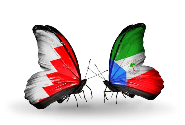 Mariposas con banderas de Bahréin y Guinea Ecuatorial en alas — Foto de Stock