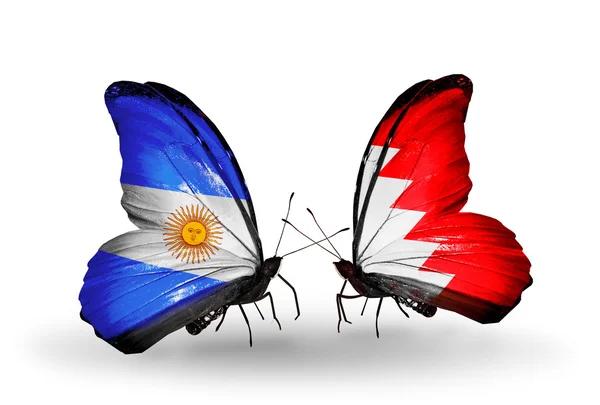 Farfalle con bandiere Argentina e Bahrein sulle ali — Foto Stock