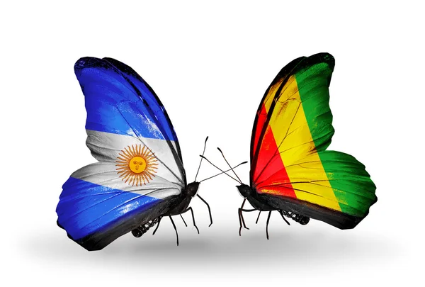 Borboletas com bandeiras da Argentina e da Guiné em asas — Fotografia de Stock