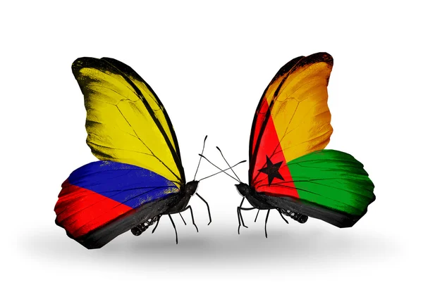 Butterflies with Columbia and Guinea Bissau flags on wings — Stock Photo, Image
