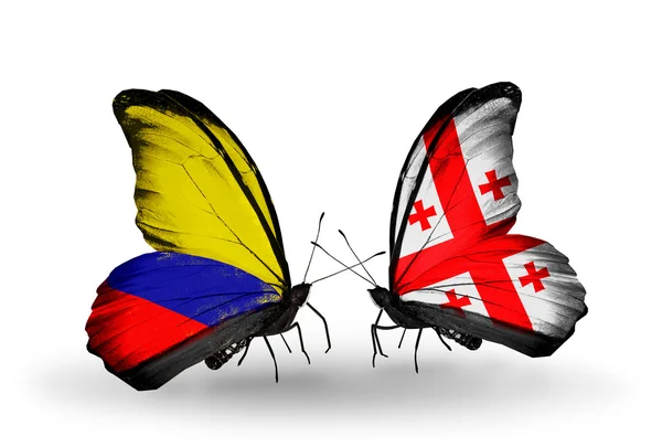 Fjärilar med columbia och Georgien flaggor på vingar — Stockfoto