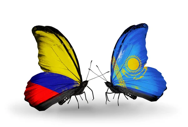 Schmetterlinge mit Kolumbien- und Kasachstan-Flaggen auf Flügeln — Stockfoto