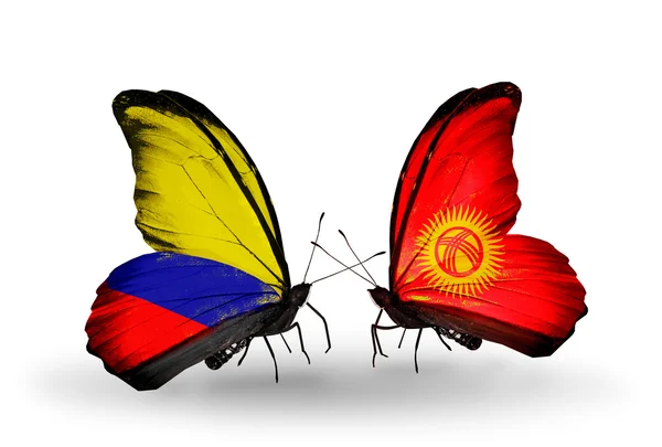 Schmetterlinge mit Kolumbien und kirgisischen Flaggen auf Flügeln — Stockfoto