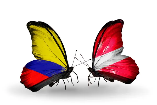 Butterflies with Columbia and Latvia flags on wings — Stock Photo, Image