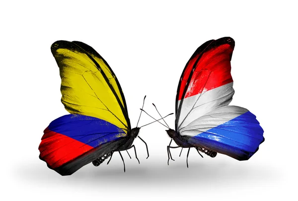 Mariposas con banderas de Colombia y Luxemburgo en alas —  Fotos de Stock