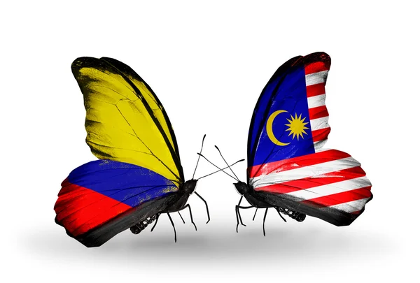 Butterflies with Columbia and Malaysia flags on wings — Stock Photo, Image