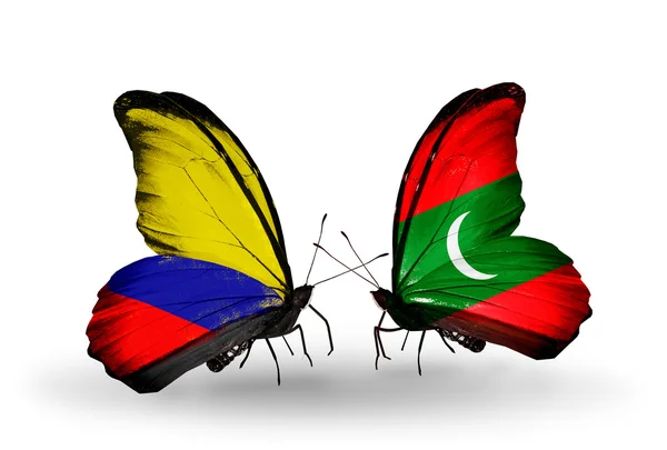 Vlinders met columbia en Maldiven vlaggen op vleugels — Stockfoto