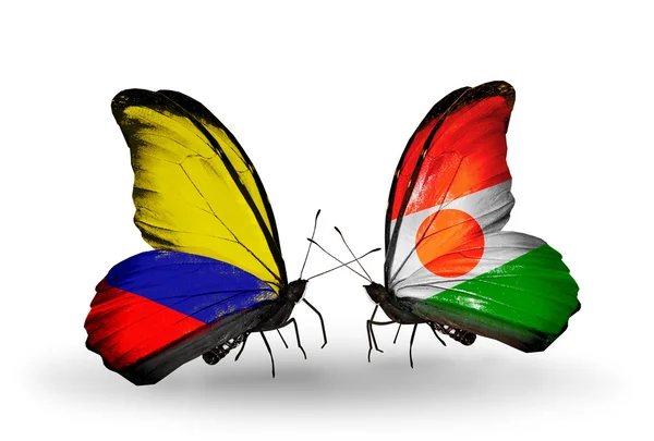 Vlinders met columbia en niger vlaggen op vleugels — Stockfoto