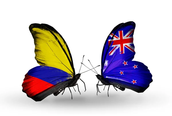 Borboletas com bandeiras Columbia e Nova Zelândia em asas — Fotografia de Stock