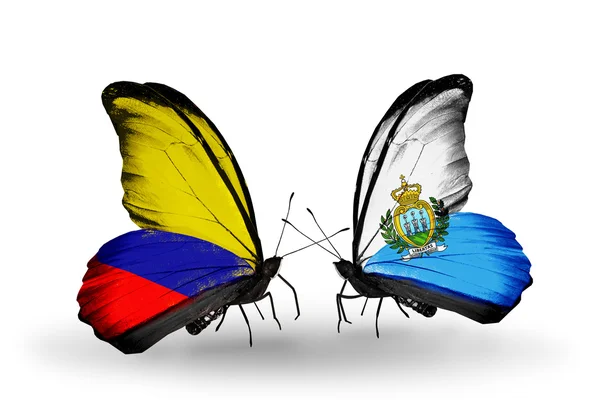 Butterflies with Columbia and San Marino flags on wings — Stock Photo, Image