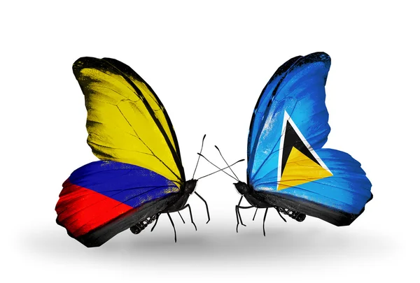 Butterflies with Columbia and Saint Lucia flags on wings — Stock Photo, Image