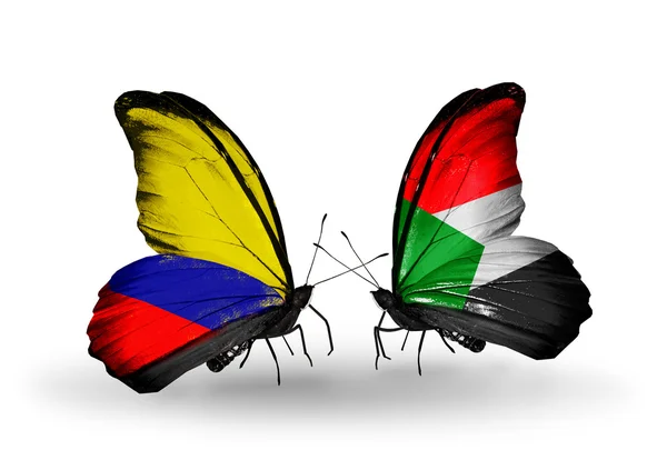 蝴蝶翅膀上的哥伦比亚和苏丹标志 — 图库照片