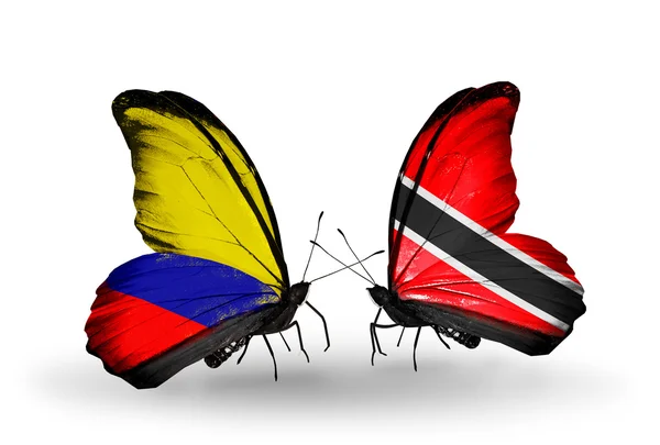 Vlinders met columbia en trinidad en tobago vlaggen op vleugels — Stockfoto