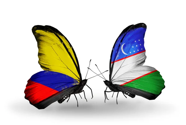 Butterflies with Columbia and Uzbekistan flags on wings — Stock Photo, Image