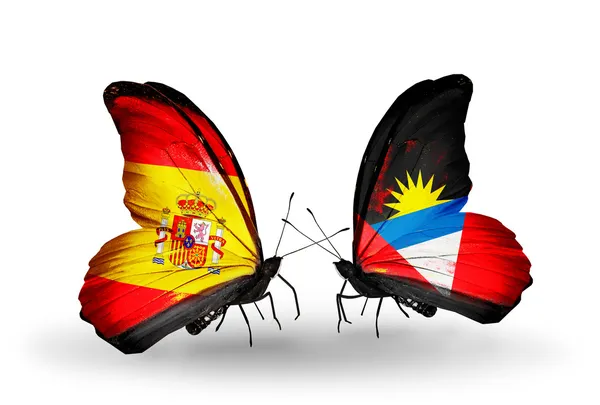 翼の上のスペインとアンティグア ・ バーブーダのフラグと蝶 — ストック写真