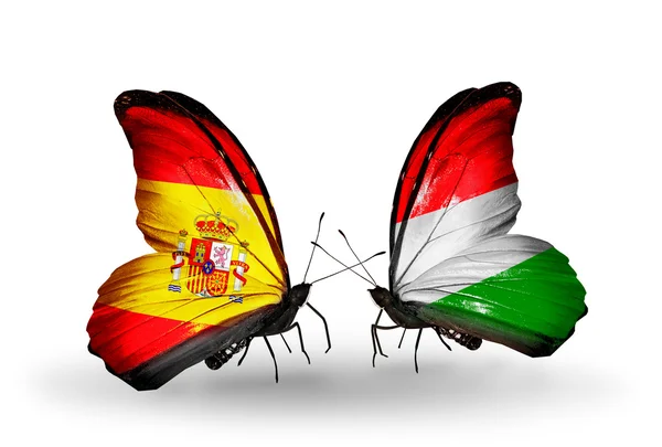 Motýli se Španělskem a Maďarskem vlajky na křídlech — Stock fotografie