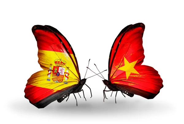 Farfalle con bandiere Spagna e Vietnam sulle ali — Foto Stock