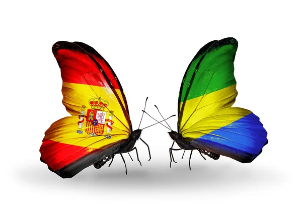 Butterflies with Spain and Gabon flags on wings — Stock Photo, Image