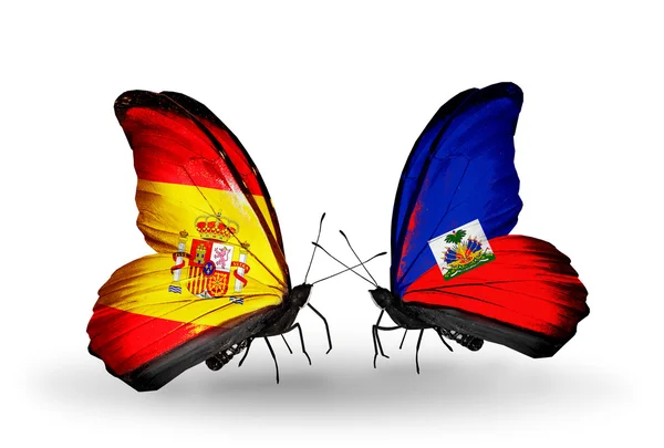 Butterflies with Spain and Haiti flags on wings — Stock Photo, Image