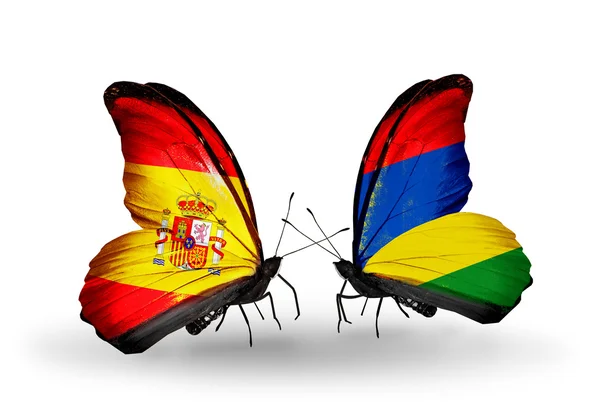 Butterflies with Spain and Mauritius flags on wings — Stock Photo, Image