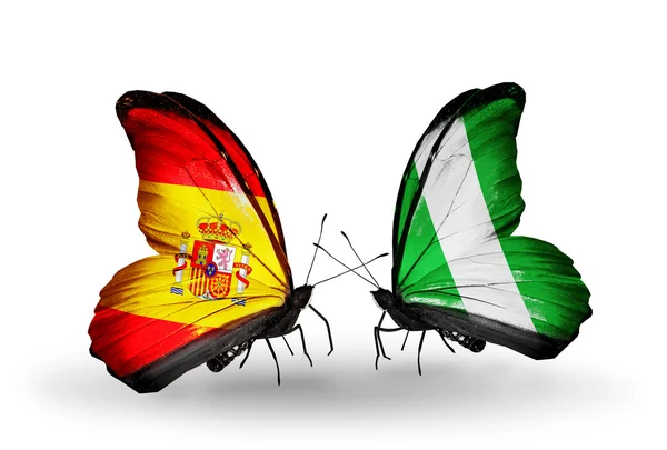 Papillons avec des drapeaux d'Espagne et du Nigeria sur les ailes — Photo