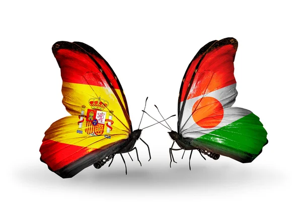 Motyle z Hiszpanii i niger flagi na skrzydłach — Zdjęcie stockowe