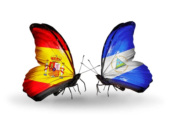 Vlinders met Spanje en nicaragua vlaggen op vleugels — Stockfoto