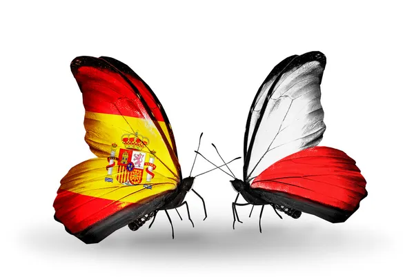 Butterflies with Spain and Poland flags on wings — Stock Photo, Image