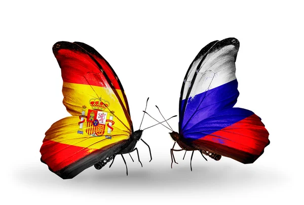 Schmetterlinge mit spanischen und russischen Flaggen auf Flügeln — Stockfoto