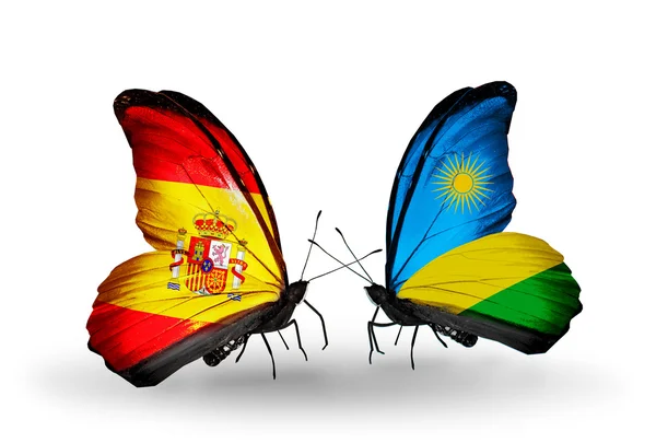 Borboletas com bandeiras de Espanha e Ruanda em asas — Fotografia de Stock