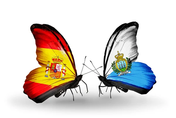 Butterflies with Spain and San Marino flags on wings — Stock Photo, Image