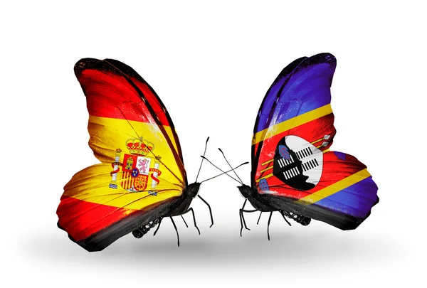 Motýli se Španělskem a Svazijska vlajky na křídlech — Stock fotografie