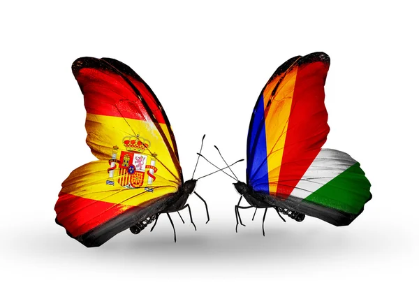 Motyle z Hiszpanii i Seszele flagi na skrzydłach — Zdjęcie stockowe