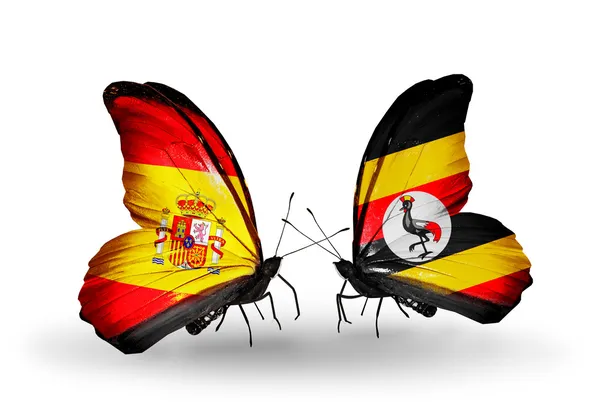 Vlinders met Spanje en Oeganda vlaggen op vleugels — Stockfoto
