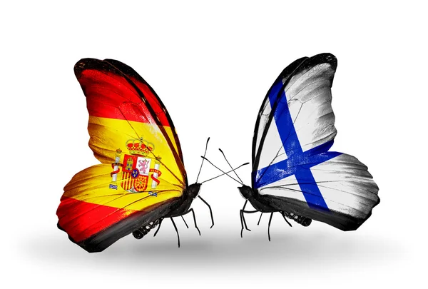 Fjärilar med Spanien och finland flaggor på vingar — Stockfoto