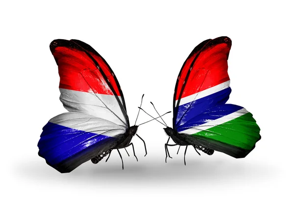 Mariposas con banderas de Holanda y Gambia en alas — Foto de Stock