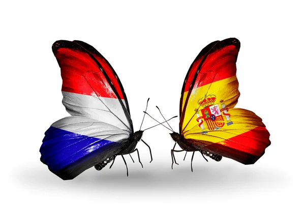 Vlinders met holland en Spanje vlaggen op vleugels — Stockfoto
