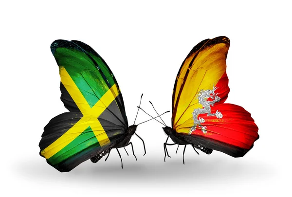 Mariposas con banderas de Jamaica y Bután en alas — Foto de Stock