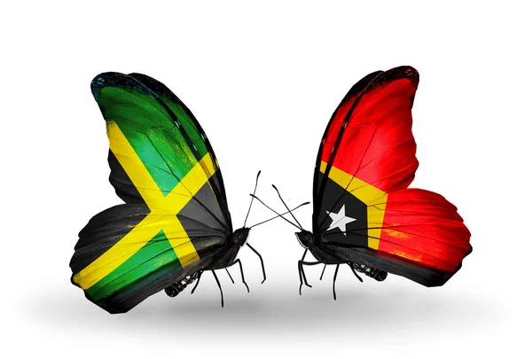 Farfalle con bandiere giamaicane e timorensi sulle ali — Foto Stock