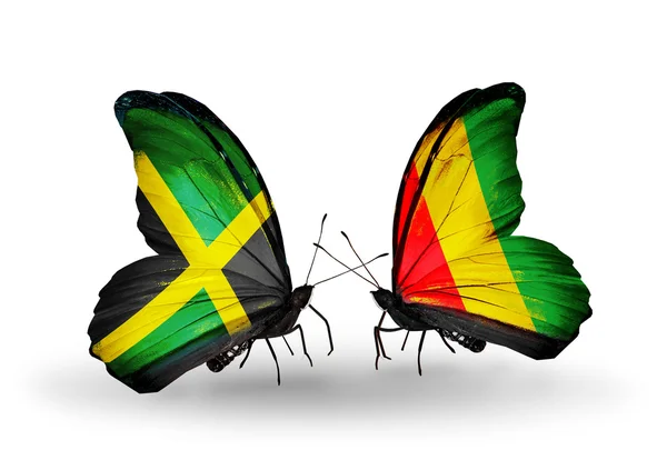 Motyle z flagami Jamajki i Gwinei na skrzydłach — Zdjęcie stockowe