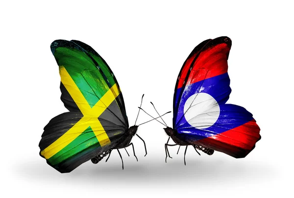 Fjärilar med jamaica och laos flaggor på vingar — Stockfoto