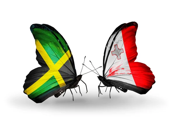 Vlinders met jamaica en malta vlaggen op vleugels — Stockfoto