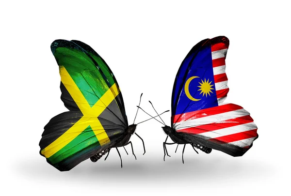 Motyle z flagami Jamajki i Malezji na skrzydłach — Zdjęcie stockowe