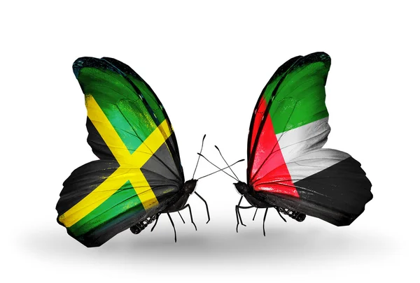 Motyle z flagami Jamajki i Zjednoczonych Emiratów Arabskich na skrzydłach — Zdjęcie stockowe