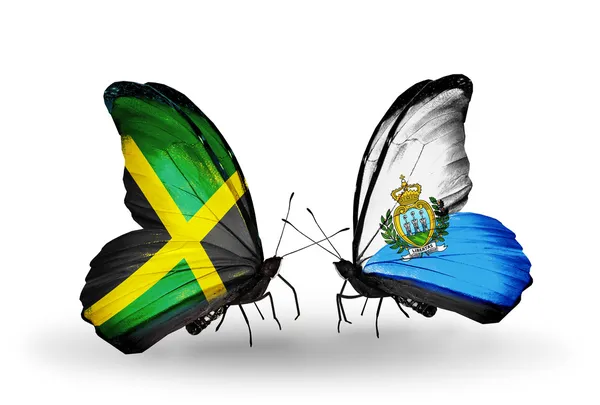 Motýli s příznaky Jamajky a san marino na křídlech — Stock fotografie