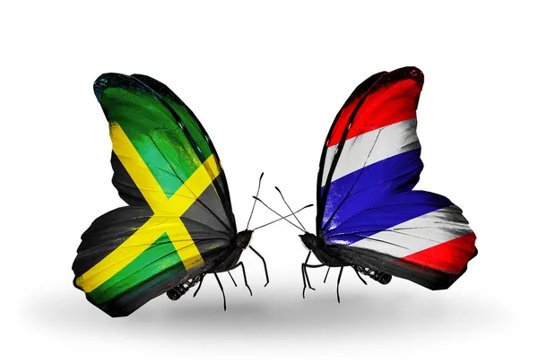 Бабочки с флагами Ямайки и Таиланда на крыльях — стоковое фото