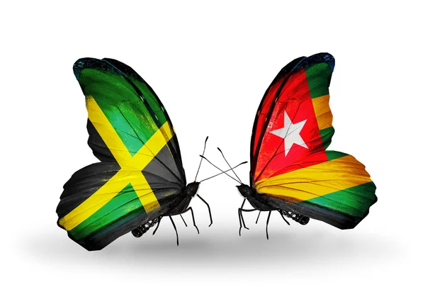 Vlinders met jamaica en togo vlaggen op vleugels — Stockfoto