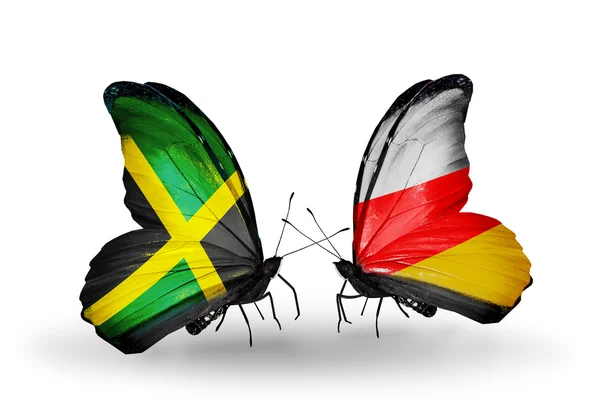 Papillons avec des drapeaux de Jamaïque et d'Ossétie du Sud sur les ailes — Photo